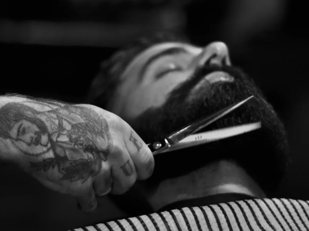 Close shot of a barber hand performing a haircut with scissors